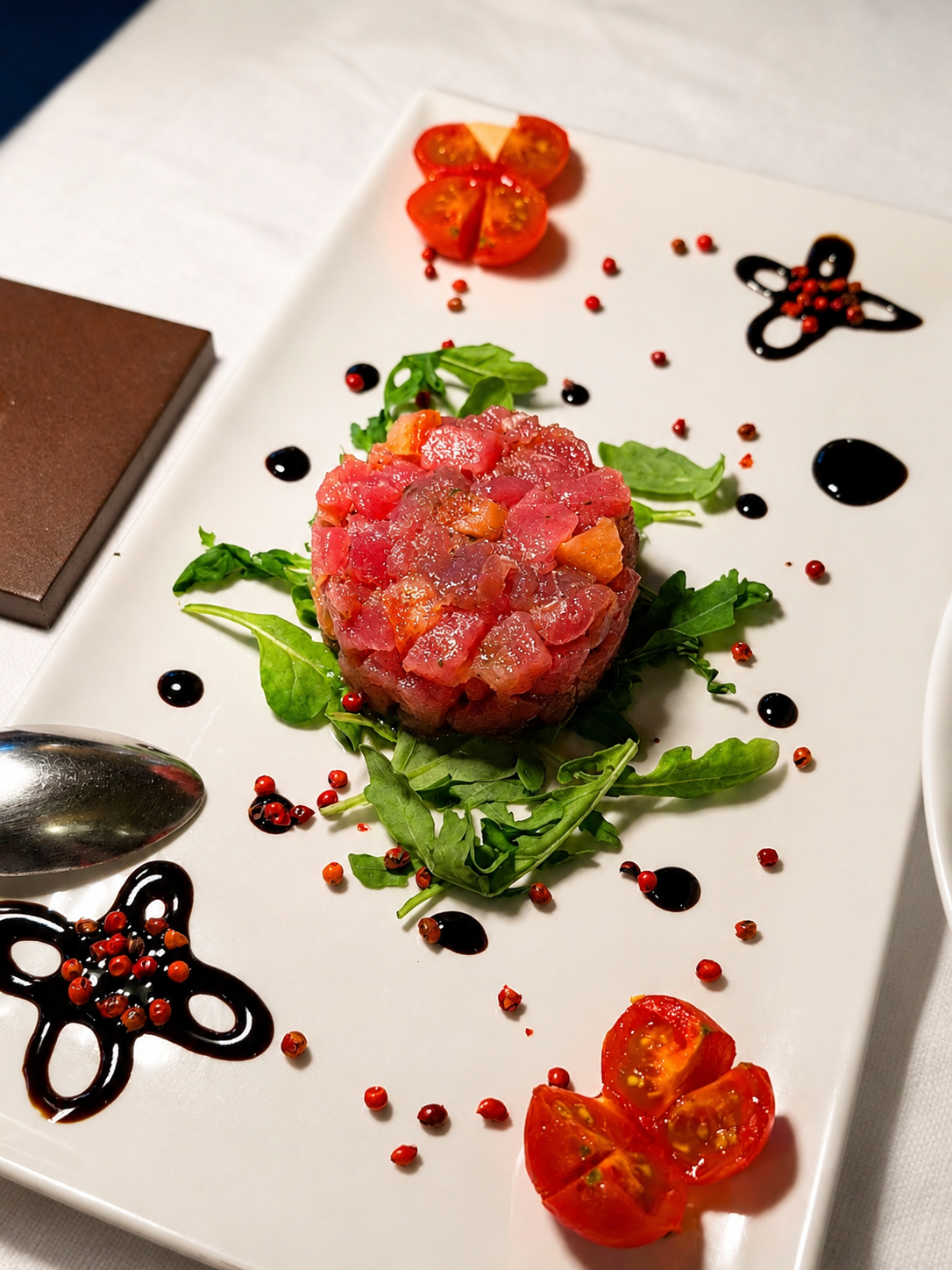 Tartare di pesce con rucola, pomodorini e riduzione